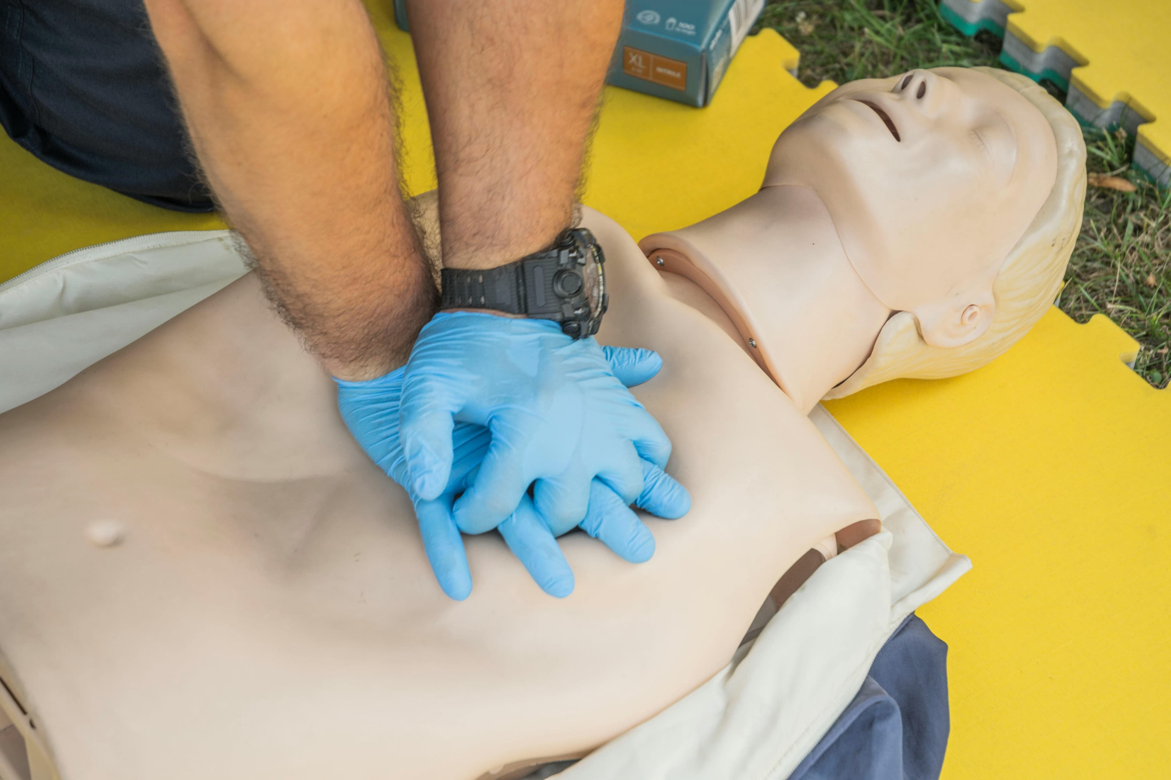 Close-up of high-quality chest compressions on a CPR manikin.