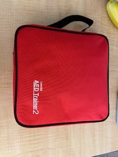 Portable AED trainer carried to every on-site class.