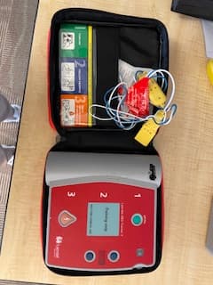 AED trainer unit opened and ready for hands-on practice.