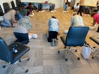 Participants practicing chest compressions during a live CPR class.