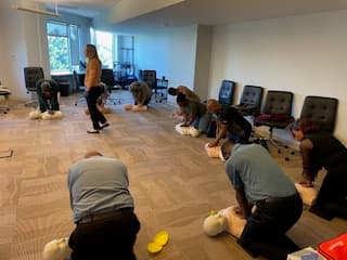 Participants rotating through hands-on CPR practice stations.